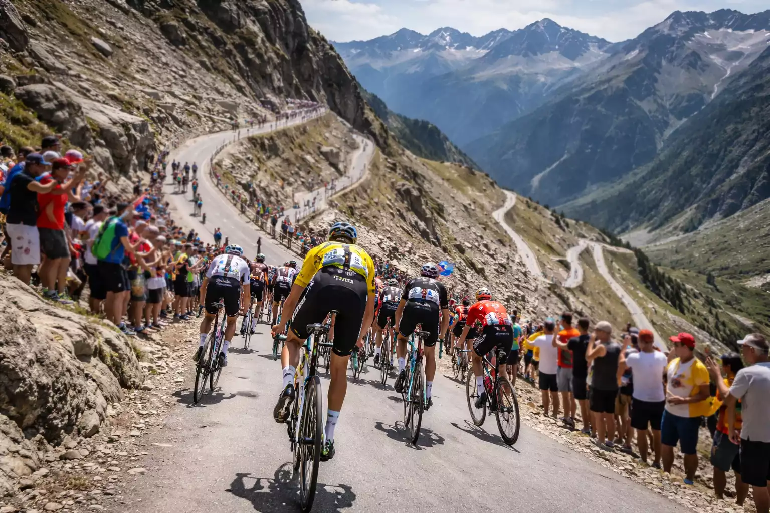 Ciclistas ascendiendo un puerto de montaña con curvas cerradas y pendiente pronunciada
